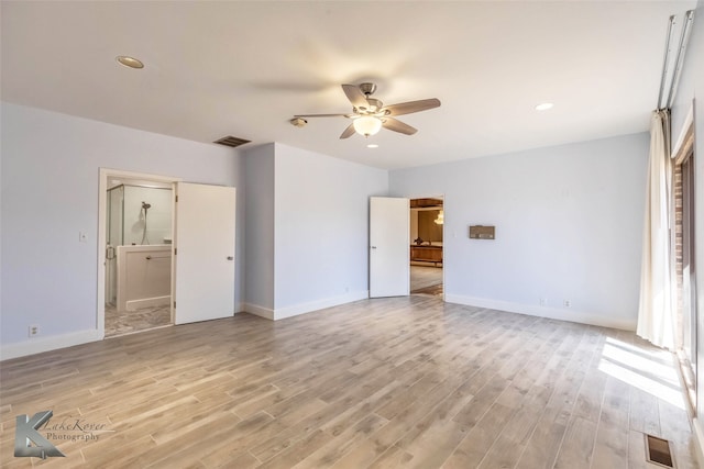 unfurnished bedroom featuring light wood-style floors, baseboards, and visible vents