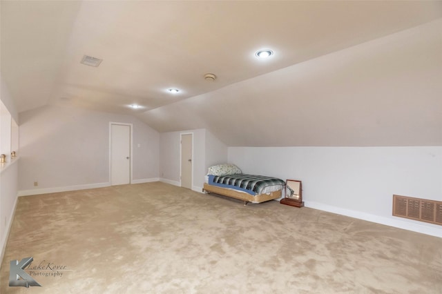 additional living space featuring vaulted ceiling, carpet, visible vents, and baseboards