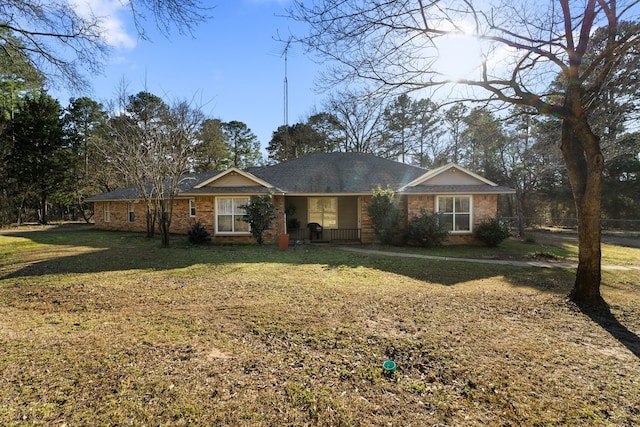 single story home with a front lawn and brick siding