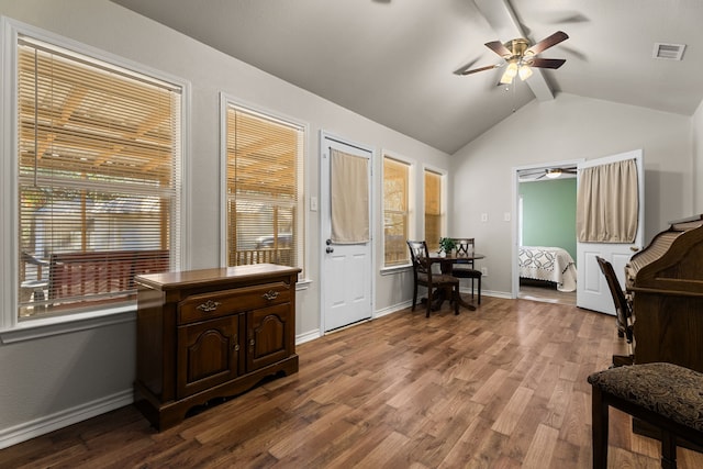 sitting room featuring visible vents, lofted ceiling with beams, ceiling fan, wood finished floors, and baseboards