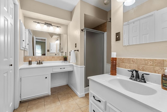 full bath with a stall shower, tile patterned flooring, and vanity