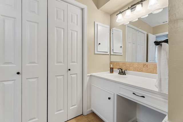 bathroom featuring tile patterned flooring, a closet, and vanity