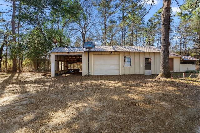 garage with driveway and a carport