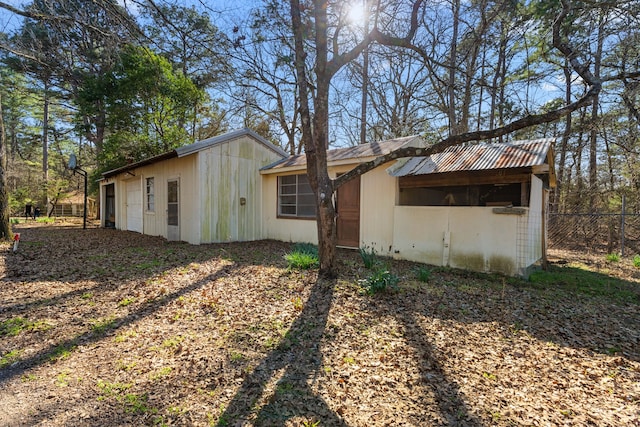 view of outbuilding featuring fence