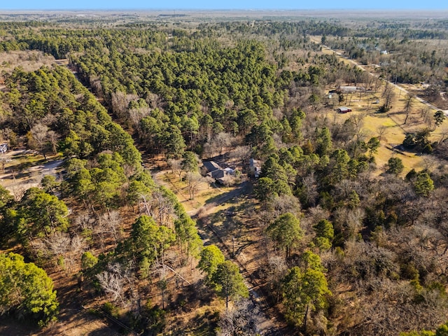 drone / aerial view featuring a forest view