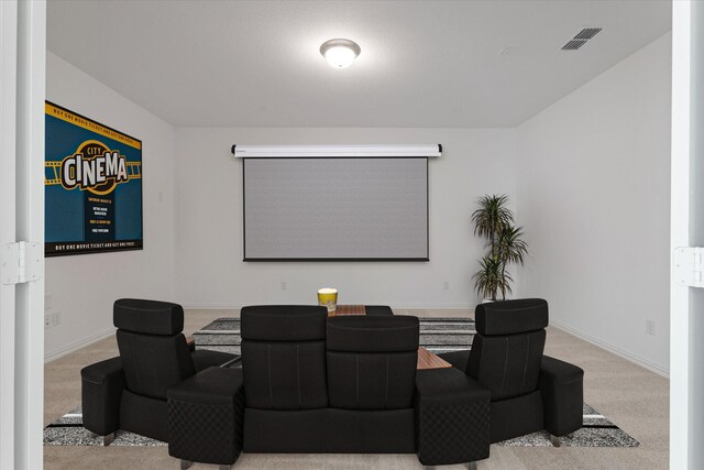 carpeted home theater room with baseboards and visible vents