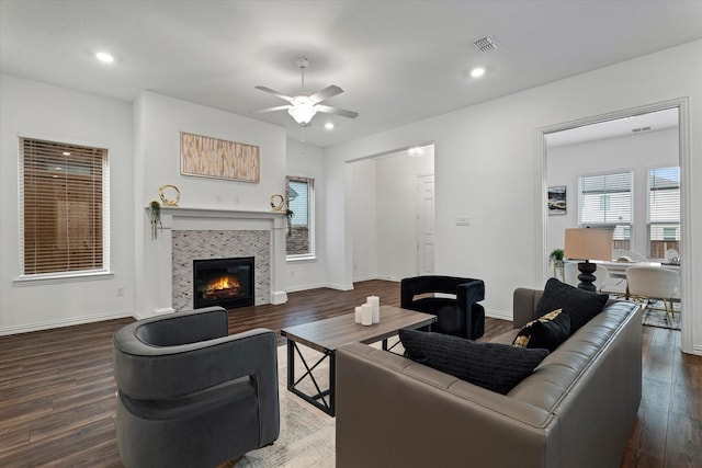 living room with a fireplace, recessed lighting, visible vents, wood finished floors, and baseboards