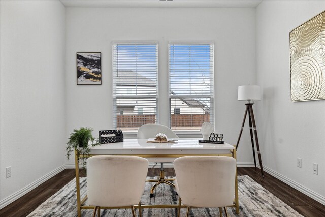 office space with baseboards and dark wood finished floors