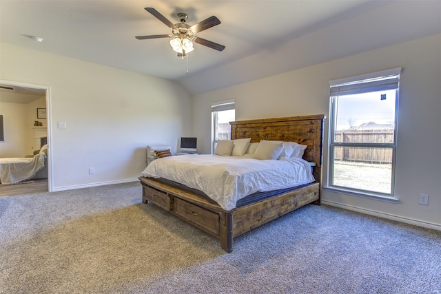 bedroom with lofted ceiling, a ceiling fan, baseboards, and carpet flooring