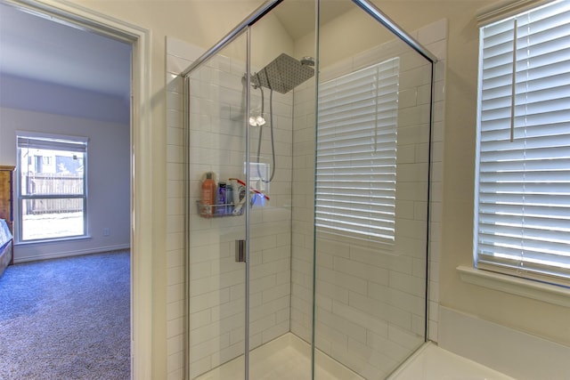 ensuite bathroom featuring a stall shower and connected bathroom