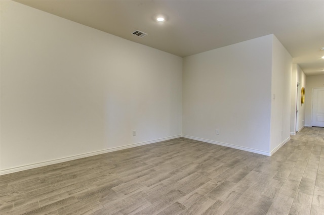 unfurnished room featuring recessed lighting, baseboards, visible vents, and light wood finished floors