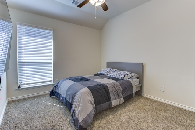 carpeted bedroom with lofted ceiling, baseboards, visible vents, and ceiling fan