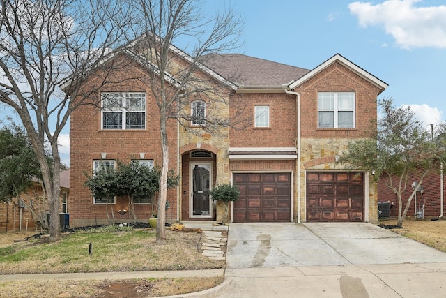 view of front of home with an attached garage, cooling unit, brick siding, stone siding, and concrete driveway