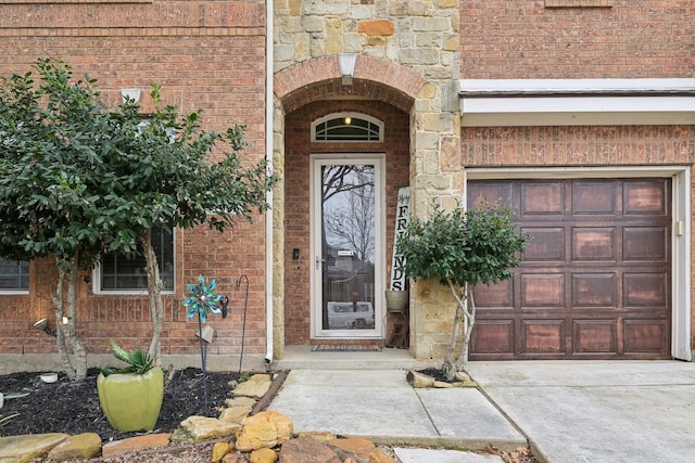 doorway to property featuring stone siding and brick siding