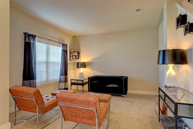 living room with carpet floors, baseboards, and visible vents