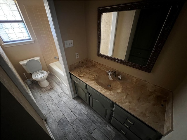 bathroom featuring walk in shower, wood finish floors, a washtub, toilet, and vanity