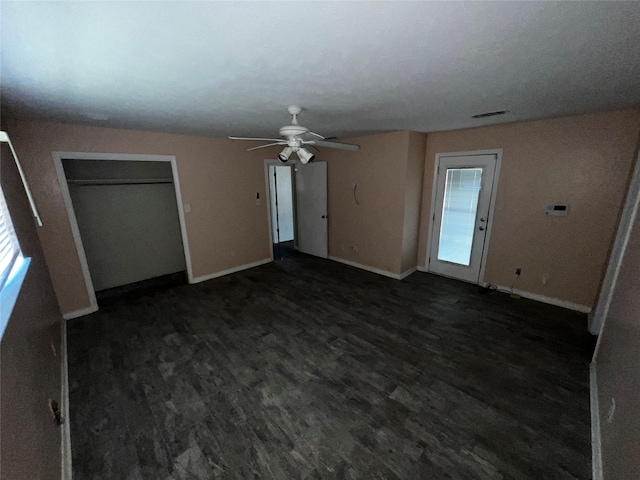 unfurnished bedroom with a ceiling fan, wood finished floors, and baseboards