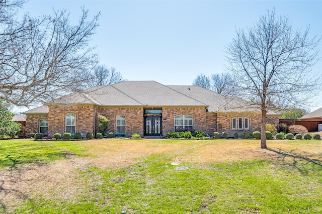 view of front of home with a front yard and brick siding