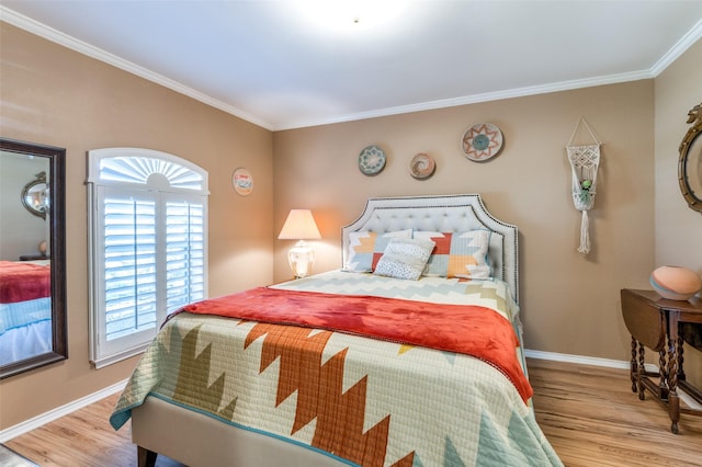 bedroom with light wood-style flooring, baseboards, and ornamental molding