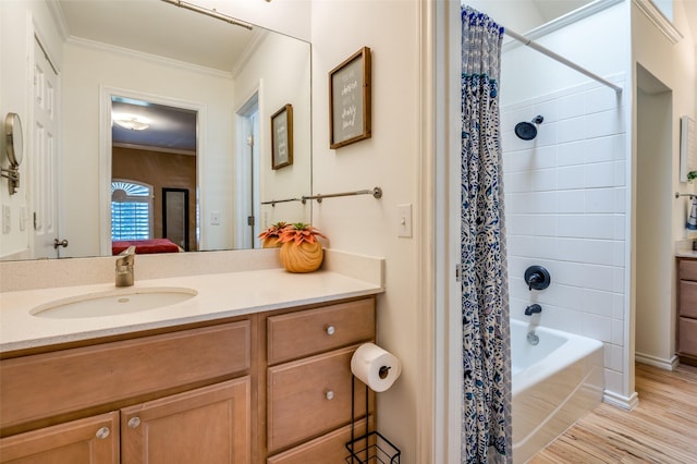 ensuite bathroom featuring connected bathroom, ornamental molding, wood finished floors, shower / bath combination with curtain, and vanity