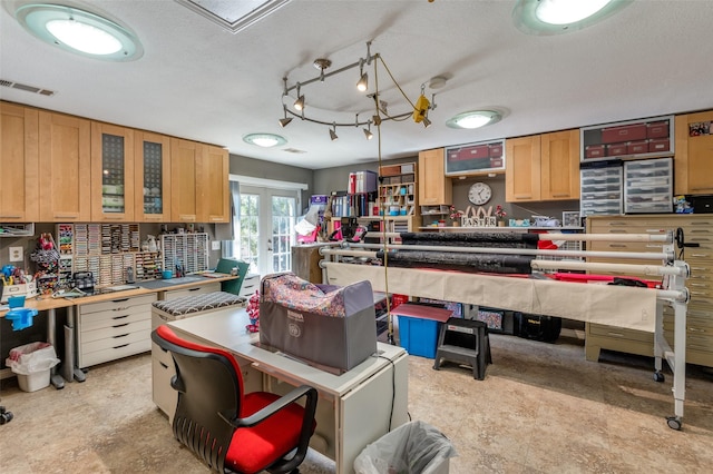 kitchen featuring visible vents, tasteful backsplash, a textured ceiling, french doors, and glass insert cabinets