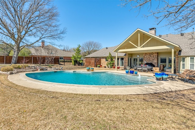 view of pool featuring a patio, fence, a fenced in pool, and a lawn