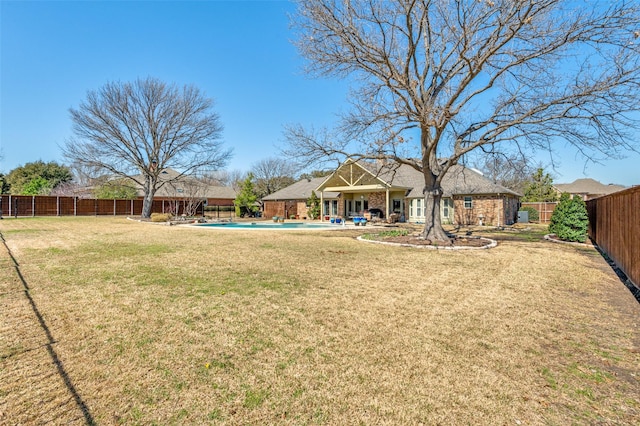 view of yard with a patio area, a fenced backyard, and a fenced in pool