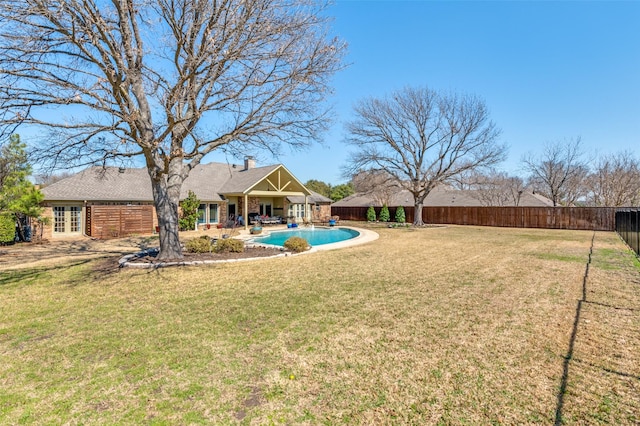 view of yard with a fenced in pool, a fenced backyard, french doors, and a patio area