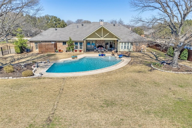 view of pool with a fenced in pool, fence, a patio area, and a lawn