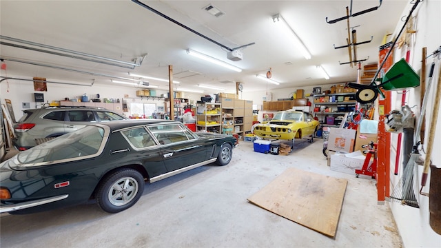 garage with visible vents and a garage door opener