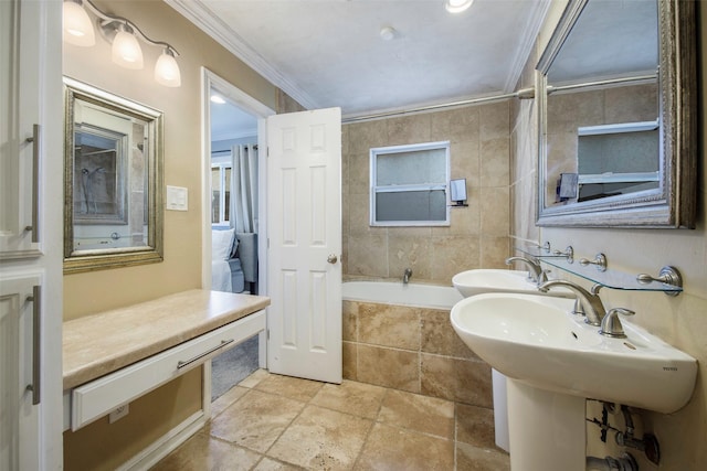 109 Belden Cir, Mckinney, TX 75069 - full bathroom featuring crown molding, a relaxing tiled tub, stone finish flooring, and a sink