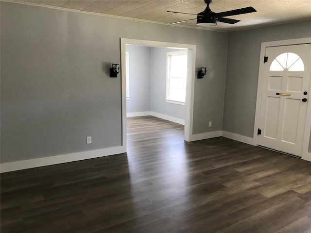 foyer entrance featuring ceiling fan, baseboards, and dark wood finished floors