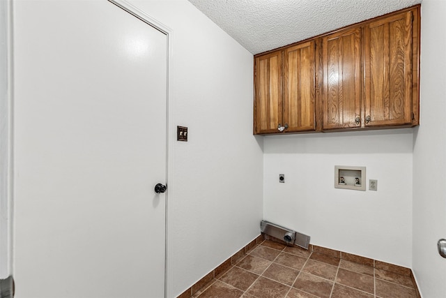 laundry area featuring a textured ceiling, hookup for a washing machine, baseboards, cabinet space, and electric dryer hookup