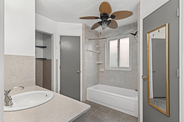 bathroom with tile patterned flooring, shower / bath combination, a textured ceiling, and tile walls