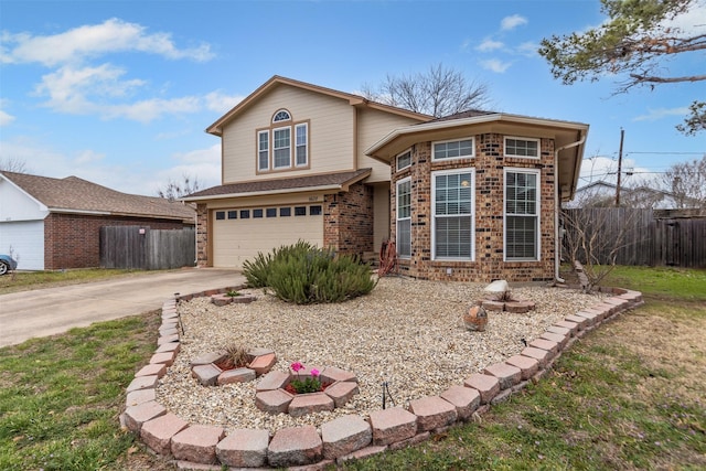 traditional-style house with brick siding, driveway, an attached garage, and fence