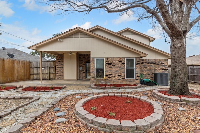 back of property featuring ceiling fan, a patio, brick siding, and fence