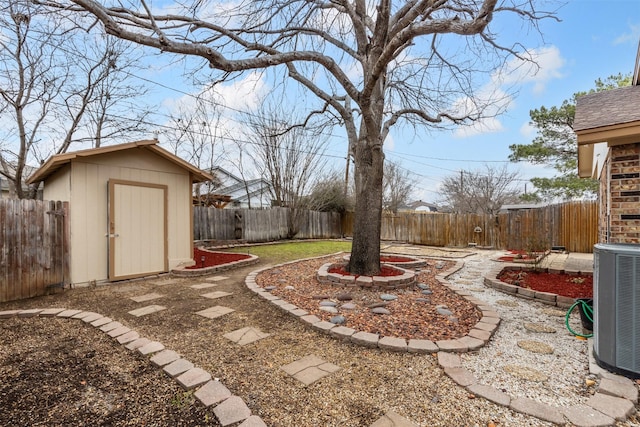 view of yard featuring central air condition unit, a storage shed, a fenced backyard, and an outdoor structure