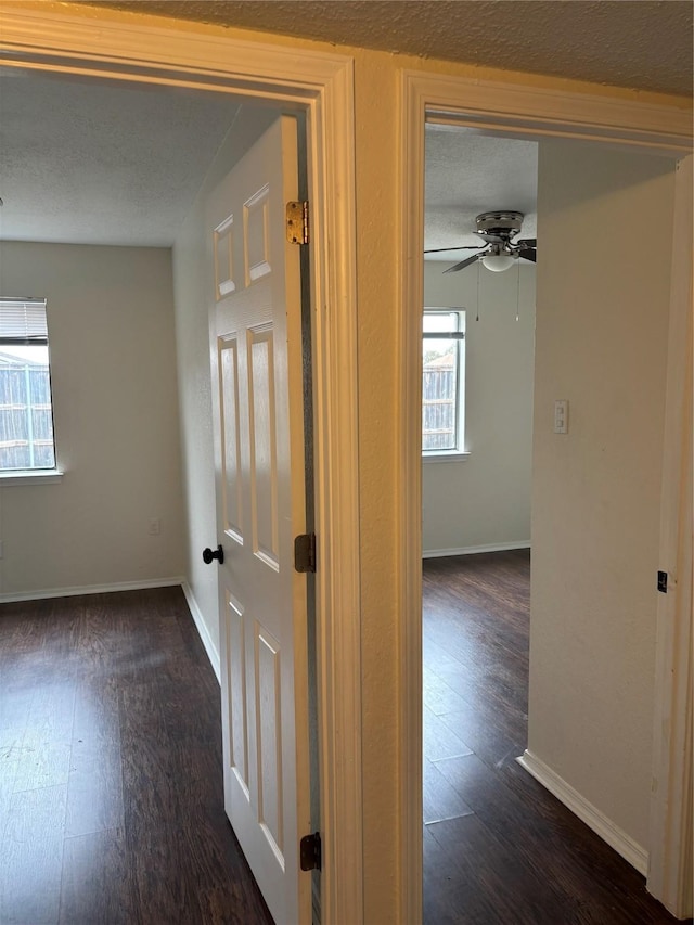 hall with wood finished floors and baseboards