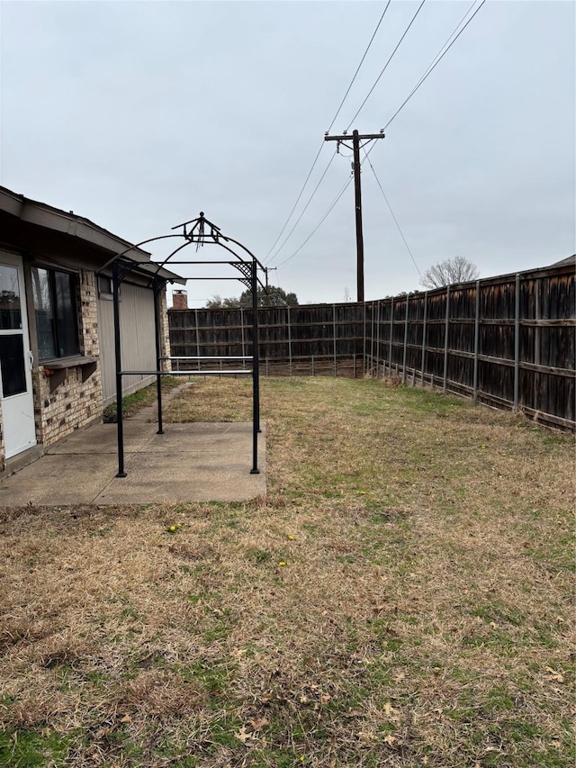 view of yard with a patio area and a fenced backyard