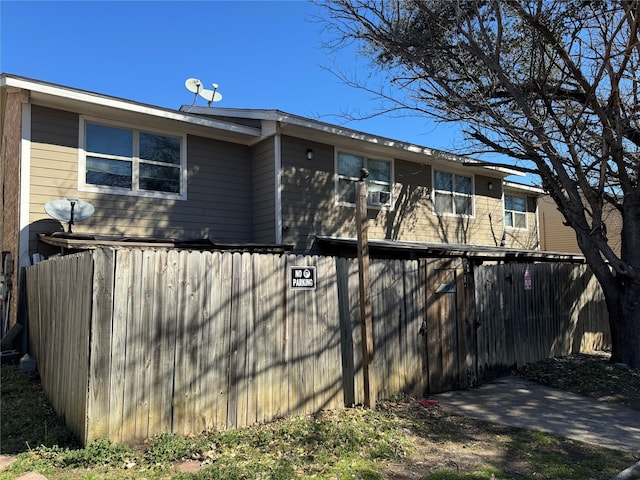 rear view of property featuring fence