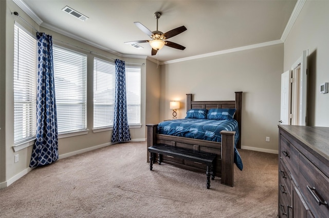 bedroom featuring crown molding, multiple windows, carpet flooring, and visible vents