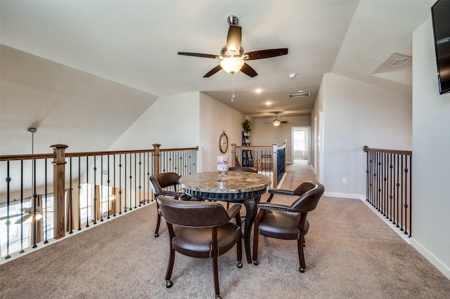 dining room with visible vents, a ceiling fan, carpet flooring, baseboards, and vaulted ceiling