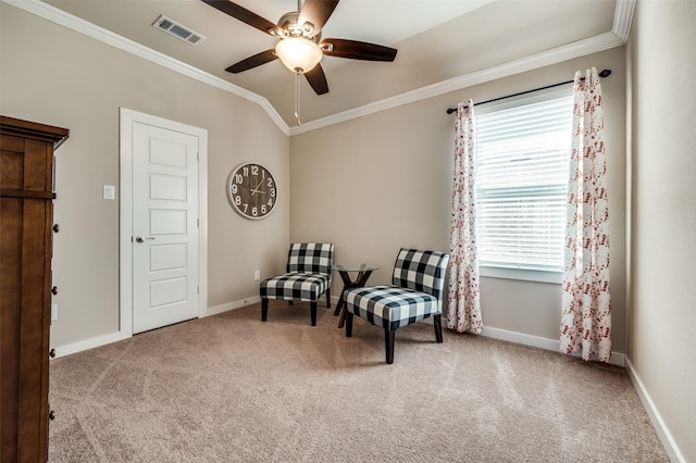 living area with visible vents, baseboards, carpet flooring, and crown molding