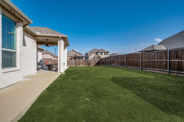 view of yard featuring a ceiling fan, a patio, and a fenced backyard