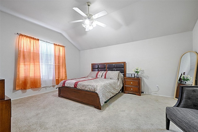 bedroom featuring a ceiling fan, vaulted ceiling, and carpet flooring