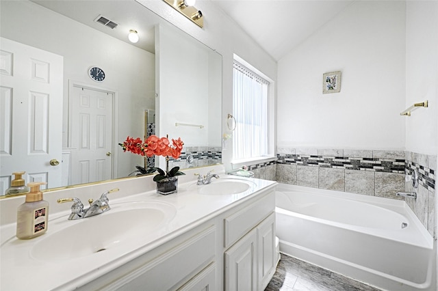 bathroom with lofted ceiling, a sink, visible vents, and a bath