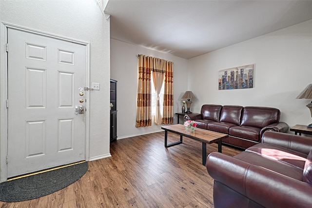 living room featuring baseboards and wood finished floors