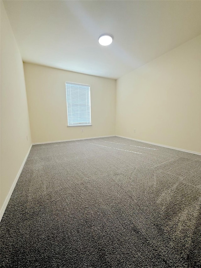 empty room with carpet and baseboards