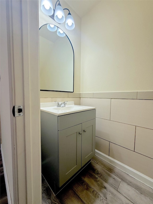 bathroom featuring a wainscoted wall, vanity, and wood finished floors