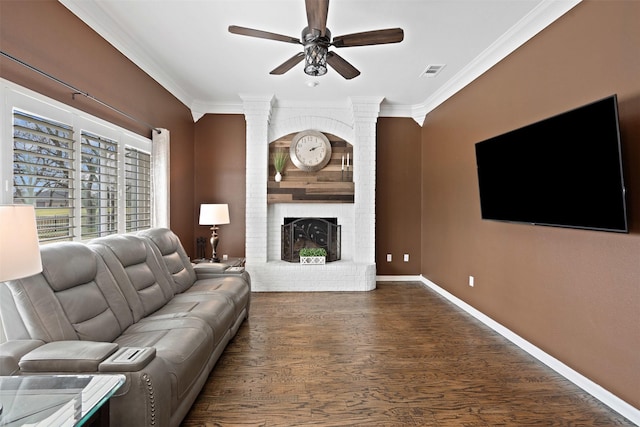 living room featuring baseboards, a brick fireplace, visible vents, and crown molding